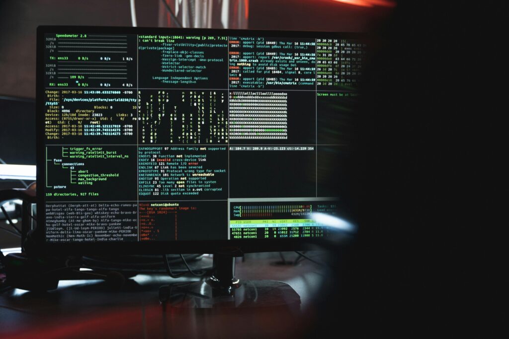 pexels-photo-5380664-5380664 Close-up of a computer monitor displaying cyber security data and code, indicative of system hacking or programming.